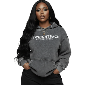 Person wearing a gray hoodie with text on a white background