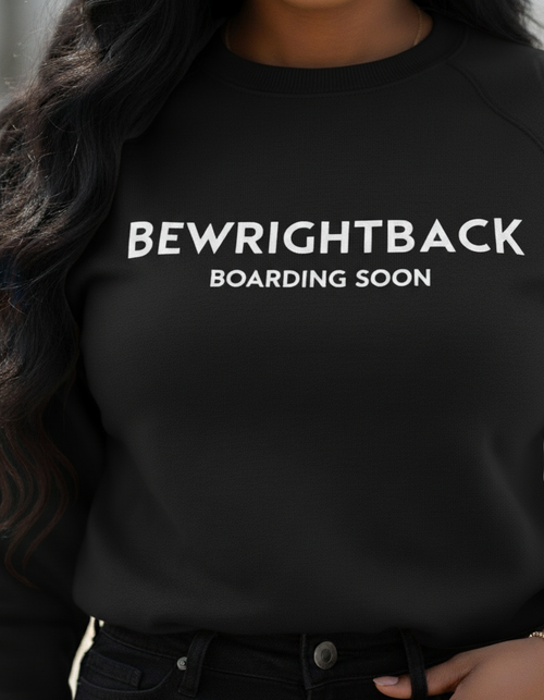 Person wearing a black sweatshirt with 'BEWRIGHTBACK BOARDING SOON' text.
